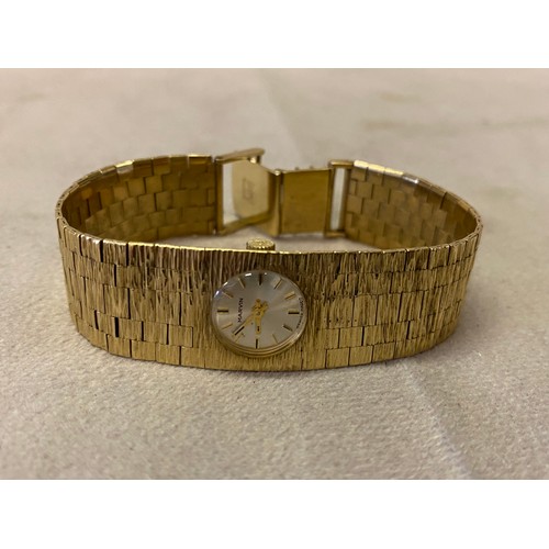 203 - A lady's Marvin wristwatch with circular dial, in a 9ct. gold case, on a 9ct. gold bark design brace... 