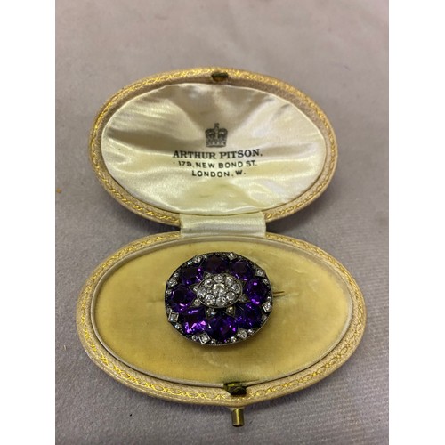 225 - A 19th Century oval brooch set with old cut diamonds and fancy cut amethysts mounted in silver, in o... 