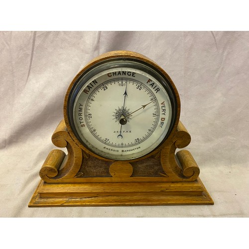 293 - A Victorian aneroid barometer on an oak mount with scroll base - 9 1/2in. high