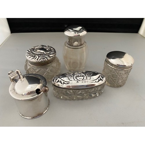 195 - A plain silver drum shaped mustard and four glass toilet jars with plain and decorated lids