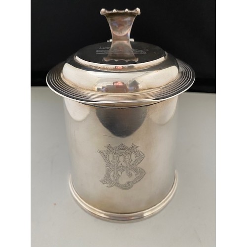 196 - A Victorian silver lidded tankard with scroll thumb piece, scroll handle, on circular foot - London ... 