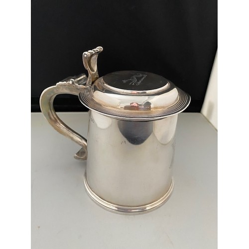 196 - A Victorian silver lidded tankard with scroll thumb piece, scroll handle, on circular foot - London ... 