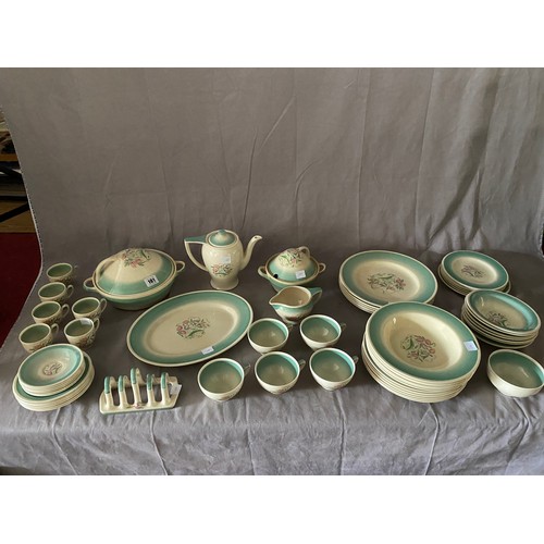 101 - A Susie Cooper part dinner service comprising:- six dinner and five dessert plates, six soup bowls, ... 