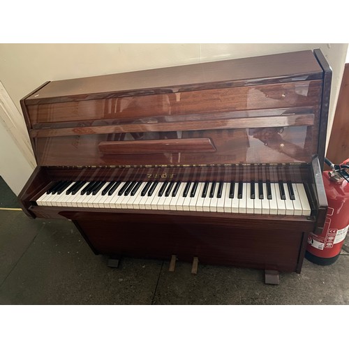 74 - A Zender mini piano in a mahogany finished case - 43in. wide