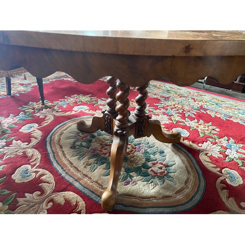 54 - A Victorian walnut veneered circular breakfast table with carved frieze, on barley twist supports an... 