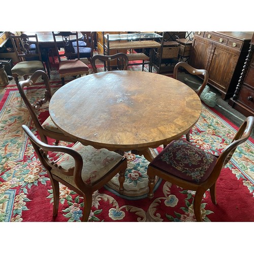 54 - A Victorian walnut veneered circular breakfast table with carved frieze, on barley twist supports an... 