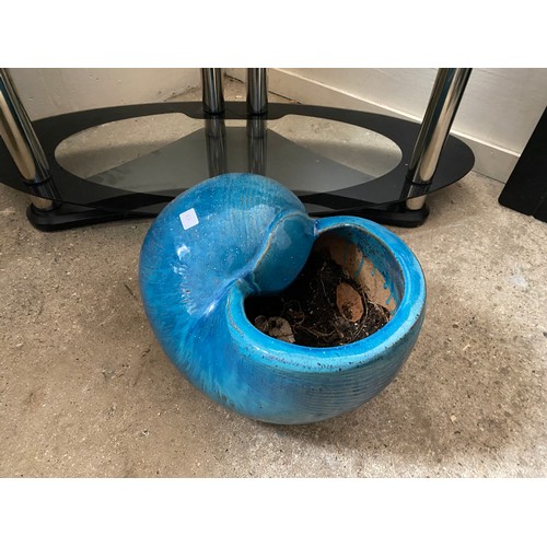 62 - A curved concrete garden seat on squirrel supports and a blue glazed planter in the form of a shell