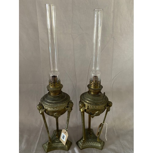 286 - A pair of Regency design brass oil lamp bases of urn form, anthemion leaf decoration, raised on thre... 