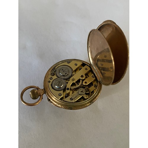 221 - A lady's openface fob watch, white enamel dial, in a 9ct. gold case with engraved and enamel flower ... 