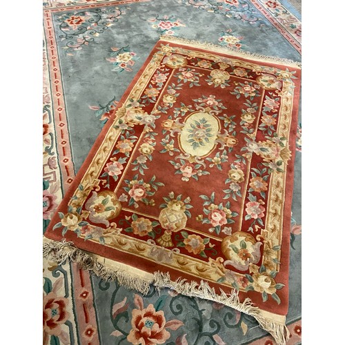 1 - A Chinese rug, red field with repeating floral decoration, fringed - 48in. x 77in.