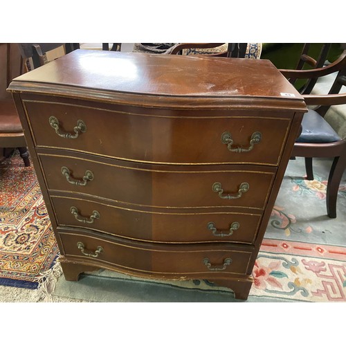 44 - A reproduction mahogany chest with serpentine shaped front, fitted four drawers - 27 1/2in. wide