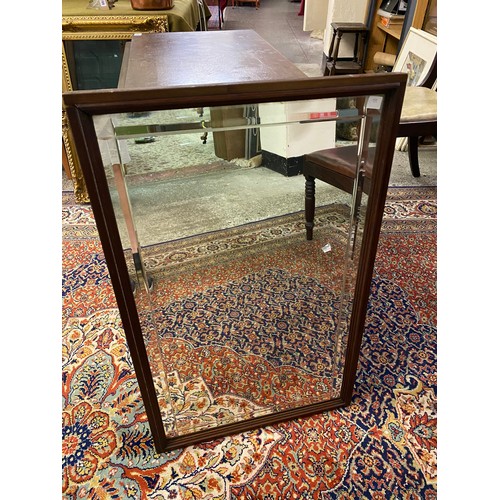 42 - An oak gateleg table fitted two rounded drop flaps, on turned legs and a rectangular wall mirror