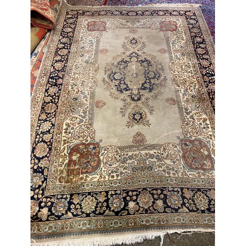 5 - A large Persian carpet, cream field with repeating floral pattern, blue floral decorated border - 13... 