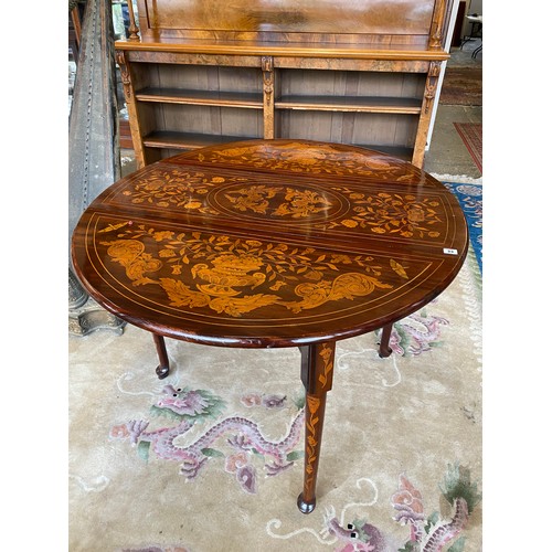 33 - A Dutch marquetry table fitted two rounded drop flaps, two drawers, on cylindrical legs terminating ... 