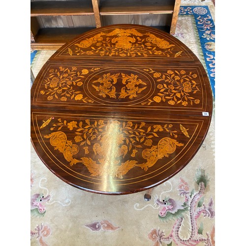 33 - A Dutch marquetry table fitted two rounded drop flaps, two drawers, on cylindrical legs terminating ... 