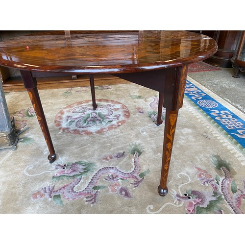 33 - A Dutch marquetry table fitted two rounded drop flaps, two drawers, on cylindrical legs terminating ... 