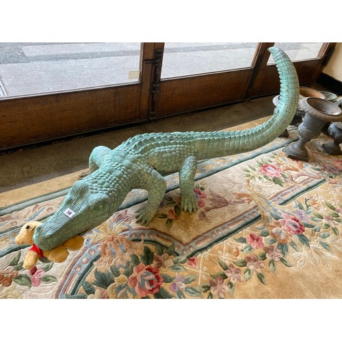 58 - A large bronze garden ornament in the form of a crocodile - 49in. long