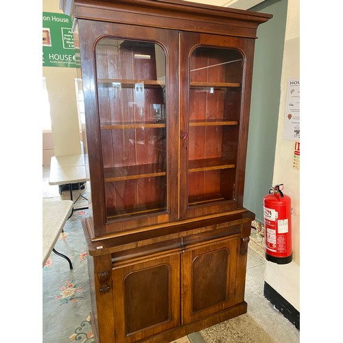 21 - A Victorian mahogany bookcase, the upper part fitted two glass doors enclosing shelves, the base fit... 