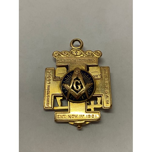 246 - A Continental gold coloured metal Masonic pendant, the front set with an eagle inset red stone, the ... 