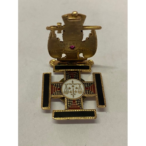 246 - A Continental gold coloured metal Masonic pendant, the front set with an eagle inset red stone, the ... 