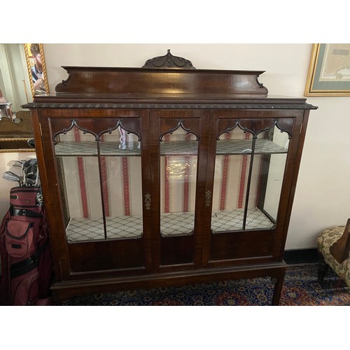 71 - A 1920's mahogany Chippendale style display cabinet with low raised back, carved edge, fitted two gl... 