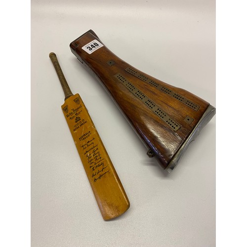 340 - A brass cribbage board set in a rifle butt and a miniature cricket bat for Australia 1962-63