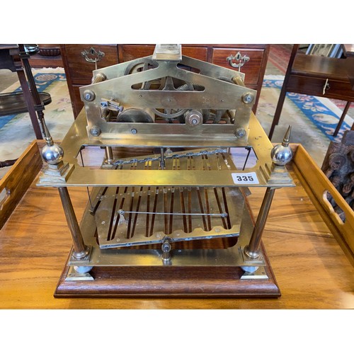 335 - A brass Congreve rolling ball clock, on later mahogany plinth