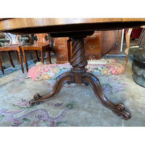 88 - A Victorian rosewood breakfast table, circular hinged top, on wrythen turned column and three downsw... 