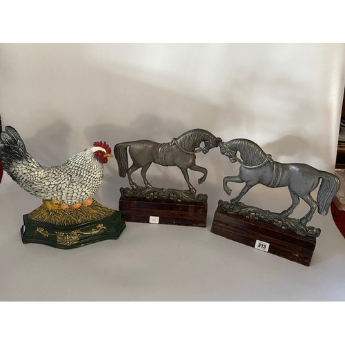 313 - A pair of metal door stops in the form of horses and one other painted metal doorstop in the form of... 