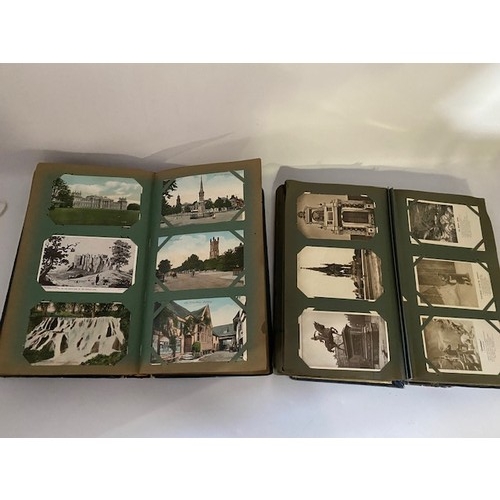 33 - Two Edwardian postcard albums containing black and white and coloured postcards