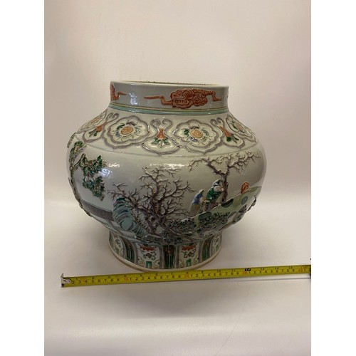 1161 - A large 19th Century Chinese bulbous vase with raised decoration of figures and flowers in famille v... 