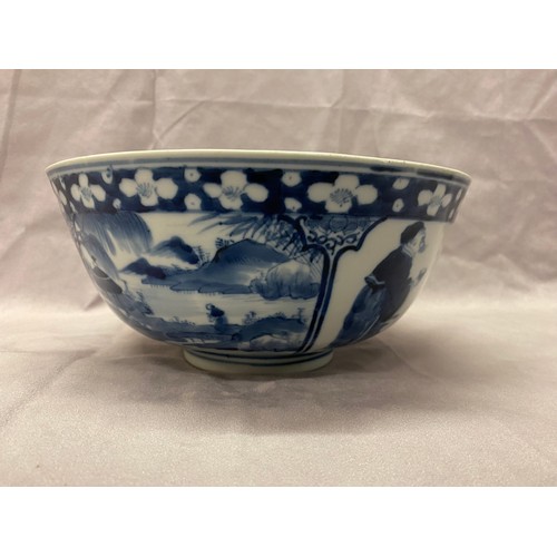 1193 - A Chinese 19th Century bowl decorated in blue and white with figures and landscapes in alternate res... 