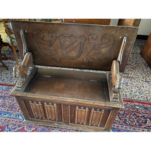 1105 - An oak monks bench with linen fold front - 42in. wide