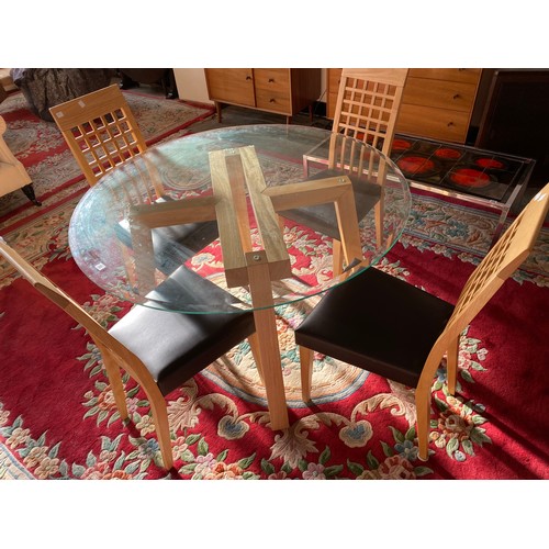 1032 - A modern dining table with circular glass top, on oak frame - 48in. dia. and a set of four matching ... 