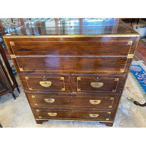 1041 - A 19th Century camphorwood and brass inlaid campaign chest with hinged writing surface, above two na... 