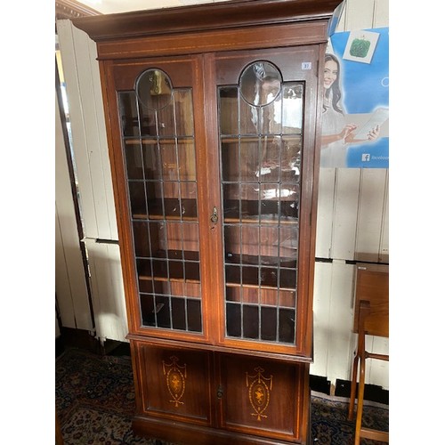 1036 - An Edwardian mahogany bookcase, the upper part with leaded glass doors, the base with satinwood inla... 