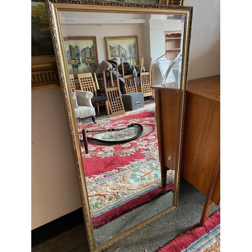 1043 - A rectangular bevelled wall mirror in a gilt frame - 51in. x 26in. and one other in a mahogany frame... 