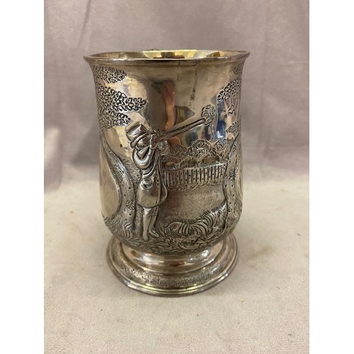 154 - A Georgian silver tankard with later repousse decoration of a gentleman shooting game, vacant cartou... 