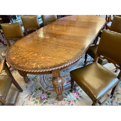 48 - An oak dining table with circular top, three extra centre leaves, on carved bulbous legs - 48in. dia... 