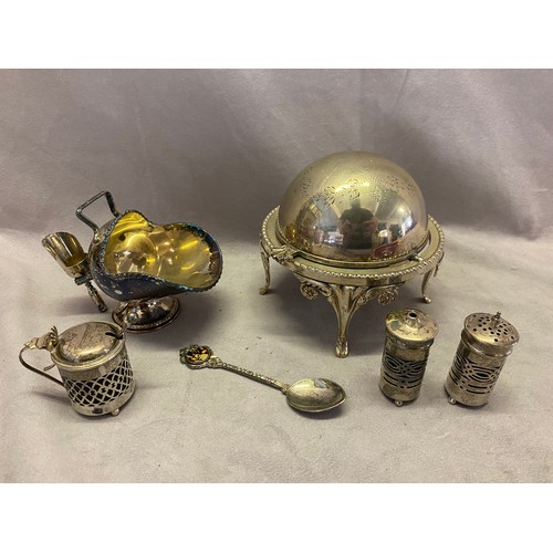 175 - A silver salt and pepperette with saw pieced decoration and blue glass liner, a similar silver drum ... 