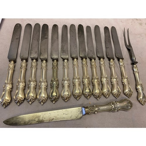 157 - A set of twelve Georgian steel table knives with silver plated handles and a matching carving knife ... 