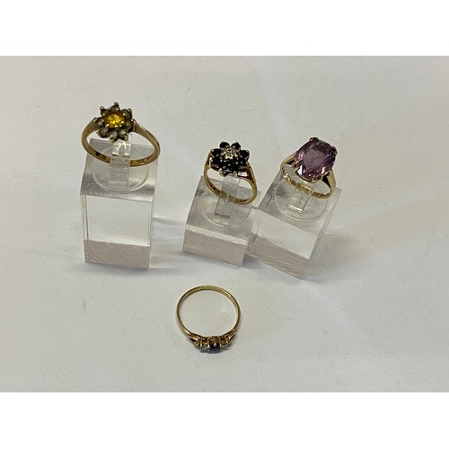 202 - A lady's ring set amethyst coloured stone, on a 9ct. gold shank, a lady's ring of flower cluster des... 