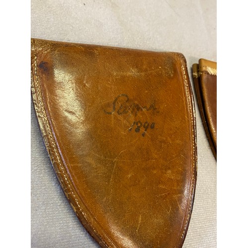 297 - A late 19th Century brown leather folding cup in fitted shield shaped leather holder