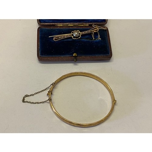 223 - A 9ct. gold bar brooch set blister pearl, in fitted box and a 1/5th 9ct. rolled gold bangle