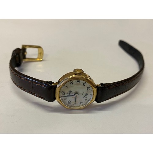 226 - A lady's Verity wristwatch with mother of pearl dial, in a 9ct. gold case, on black leather strap