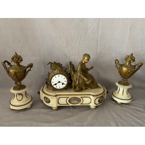 278 - A French mantel clock, white enamel dial, drum shaped movement, in a spelter case with musical troph... 