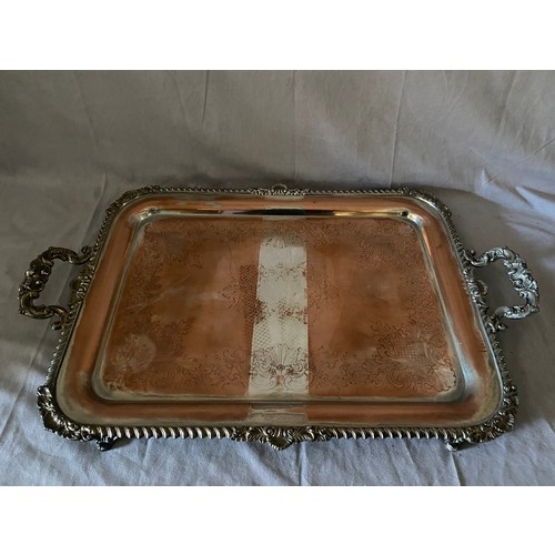 156 - A large silver plate on copper double handled tray with engraved decoration, on scroll feet - 24in. ... 