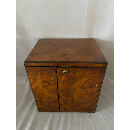 282 - A Victorian walnut veneered box fitted door, inset brass handles, the interior fitted four drawers -... 