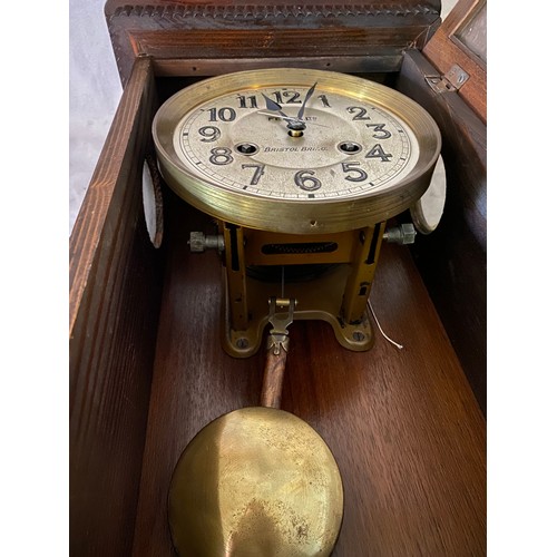 46 - A wall clock by Fears Ltd with silvered dial, in an oak case and a mahogany framed stool with cane s... 