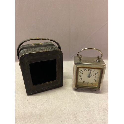 309 - A 1920's travelling clock in a chrome finished case, with leather carrying case - 2 1/4in. high